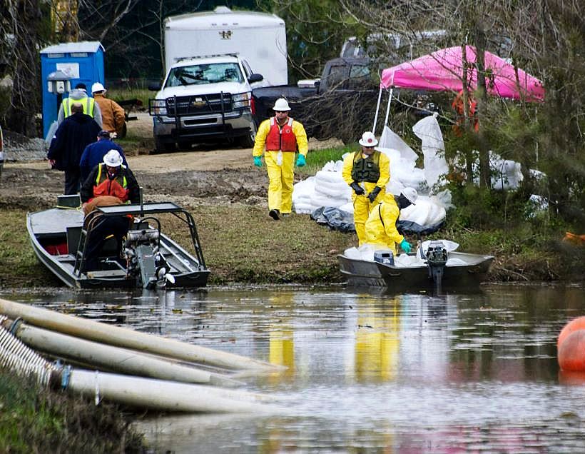 Workers clean up oil following ExxonMobil's Pegasus pipeline rupture