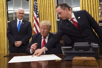Donald Trump signing executive orders on his first day as President