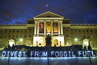 The Overpass Light Brigade sends a message to the University of Wisconsin, urging divestment from fossil fuel companies. Credit: Joe Brusky/CC-BY-NC-2.0