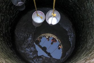 Indian villagers collect water for drinking from a well running dry at Padal village of the district of Samba on June 2, 2019. Credit: Rakesh Bakshi/AFP/Getty Images