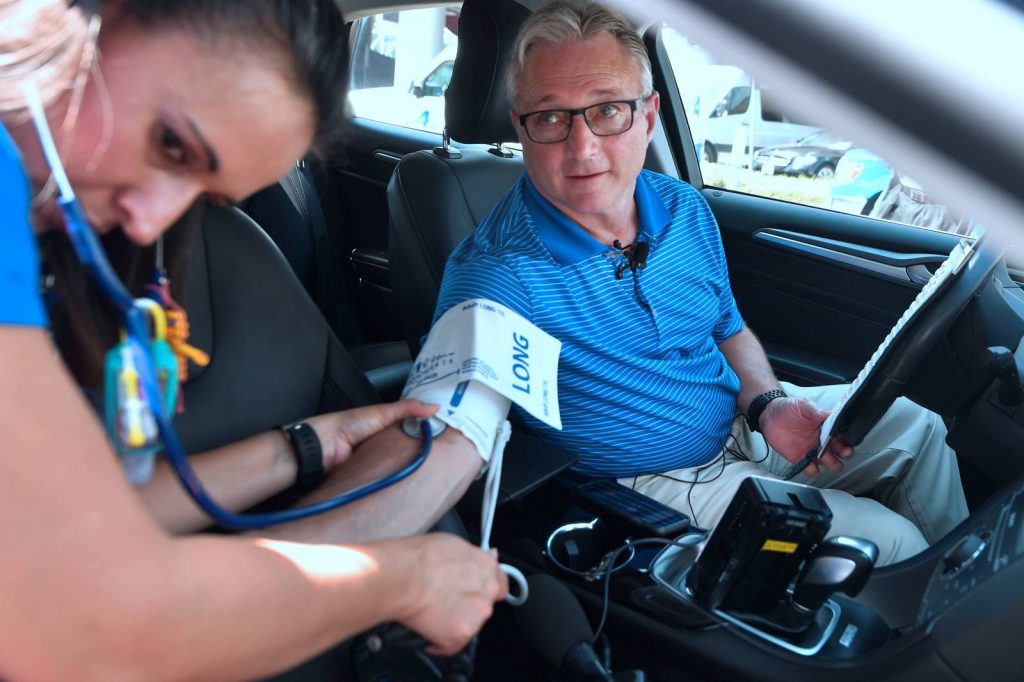 A medical team in Orange, California, with a doctor as the test subject, tests the impact of rising heat inside a car on the human body. Credit: Frederic J. Brown/AFP/Getty Images