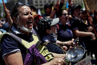 People demonstrate against the government economic policies in front of the presidential palace in Santiago, Chile, on Oct. 30, 2019. Credit: Martin Bernetti/AFP/Getty Images