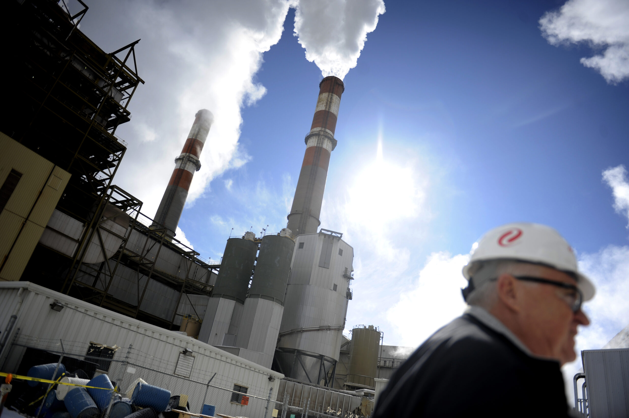 An employee walks in front of two smoke stacks at the Comanche Power Station on Wednesday, Feb. 2, 2011. Credit: AAron Ontiveroz/The Denver Post via Getty Images