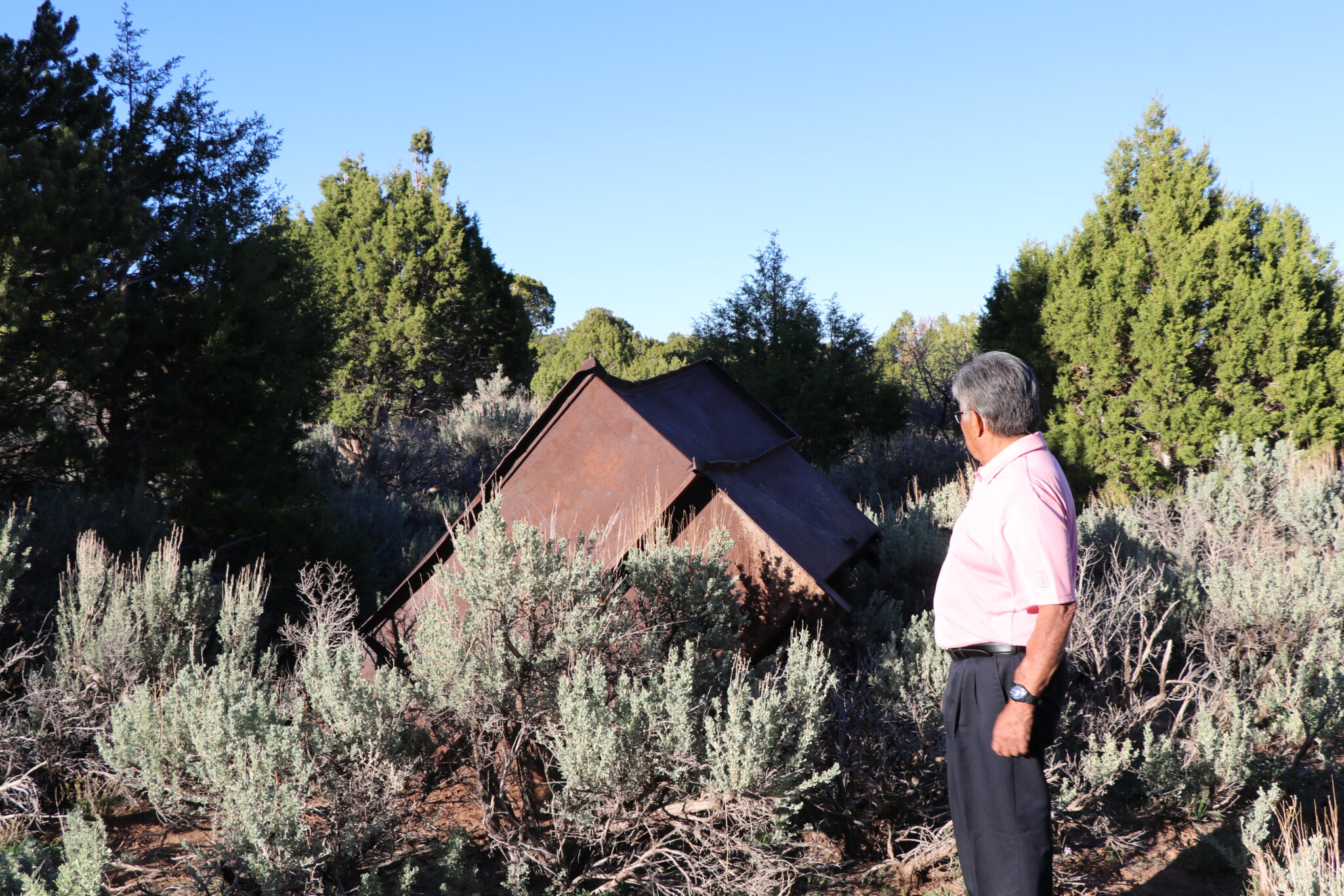 Phil Harrison views a uranium loading bin left behind from the mining era, which stretched from the 1940s to the 1980s. Credit: Cheyanne M. Daniels/MNS