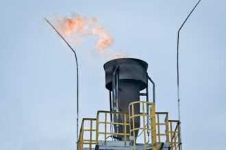 Safety flame flares out of the the barge extracting methane gas on Lake Kivu, at the Kivuwatt power plant in Kibuye, Karongi District, in the Western Province of Rwanda, on Nov. 1, 2021. -Credit: Simon Maina/AFP via Getty Images