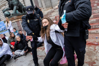 Police take protesters out during an action of Scientist Rebellion to denounce the climate situation on April 6, 2022 in Madrid, Spain. Scientists and researchers threw fake blood at the Congress of Deputies building, one of many protests planned across the globe between April 4 to 9, 2022 by the international movement Scientist Rebellion. Credit: Aldara Zarraoa/Getty Images
