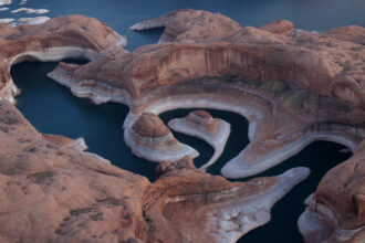 The tall bleached "bathtub ring" is visible on the rocky banks of Lake Powell at Reflection Canyon on June 24, 2021 in Lake Powell, Utah. Credit: Justin Sullivan/Getty Images
