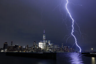 A bolt of lightning strikes next to lower Manhattan and One World Trade Center in New York City during a thunderstorm on Aug. 27, 2020 as seen from Jersey City, New Jersey. Credit: Gary Hershorn/Getty Images