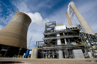 American Electric Power's Mountaineer coal power plant opened a carbon capture unit (center right), alongside the plant's cooling tower and stacks in 2009. The project was shut down in 2011 due to financial reasons. Credit: Saul Loeb/AFP via Getty Images