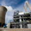 American Electric Power's Mountaineer coal power plant opened a carbon capture unit (center right), alongside the plant's cooling tower and stacks in 2009. The project was shut down in 2011 due to financial reasons. Credit: Saul Loeb/AFP via Getty Images