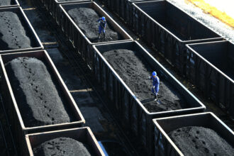 Employees work on a freight train loaded with coal at Jiangxi Coal Reserve Center on Aug. 19, 2022 in Jiujiang, Jiangxi Province of China. Credit: VCG via Getty Images