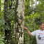 Donald Moncayo, president of The Union of People Affected by Texaco, stands next to an oil stained handprint at a former Texaco drilling site in the province of Sucumbíos, Ecuador on Aug. 11, 2022. Credit: Katie Surma/Inside Climate News