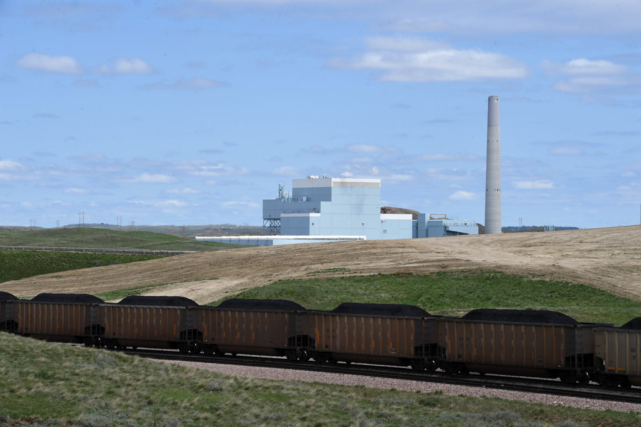 A train carrying cars loaded with coal leaving a nearby coal mine is seen in front of Dry Fork Station, a coal fired power plant operated by Basin Electric Power Cooperative on Monday May 8, 2017 in Gillette, Wyoming. Credit: Matt McClain/The Washington Post via Getty Images