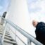 Hans-Hermann Magens, ascends the stairs to the newest windmill in the northern village of Raa-Besenbek, Germany Credit: Evan Robinson-Johnson, Medill News Service