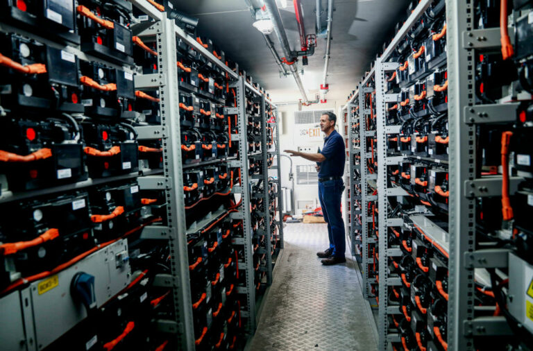 Mike Ferry, with the University of California San Diego Center for Energy Research, shows a bank of Lithium Ion batteries at UCSD