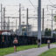 People pass electrical power lines on a a bike path in Arlington, Va. Credit: Andrew Caballero-Reynolds/AFP via Getty Images
