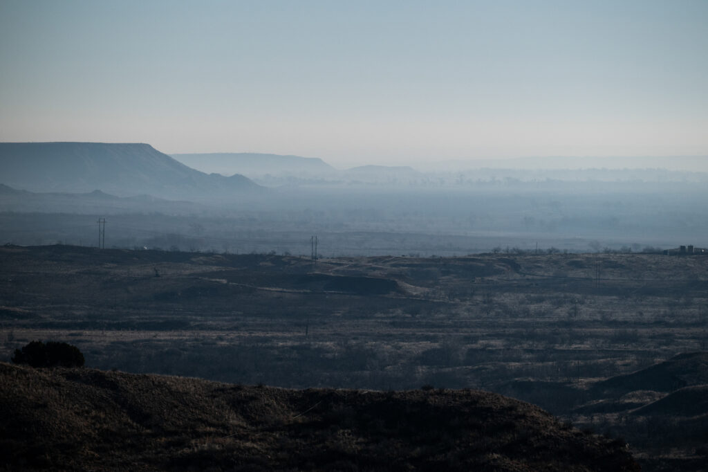 Smoke hangs in the Canadian River Valley south of Stinnett, Texas after multiple days of wild fires on March 1. Credit: Justin Rex/The Texas Tribune