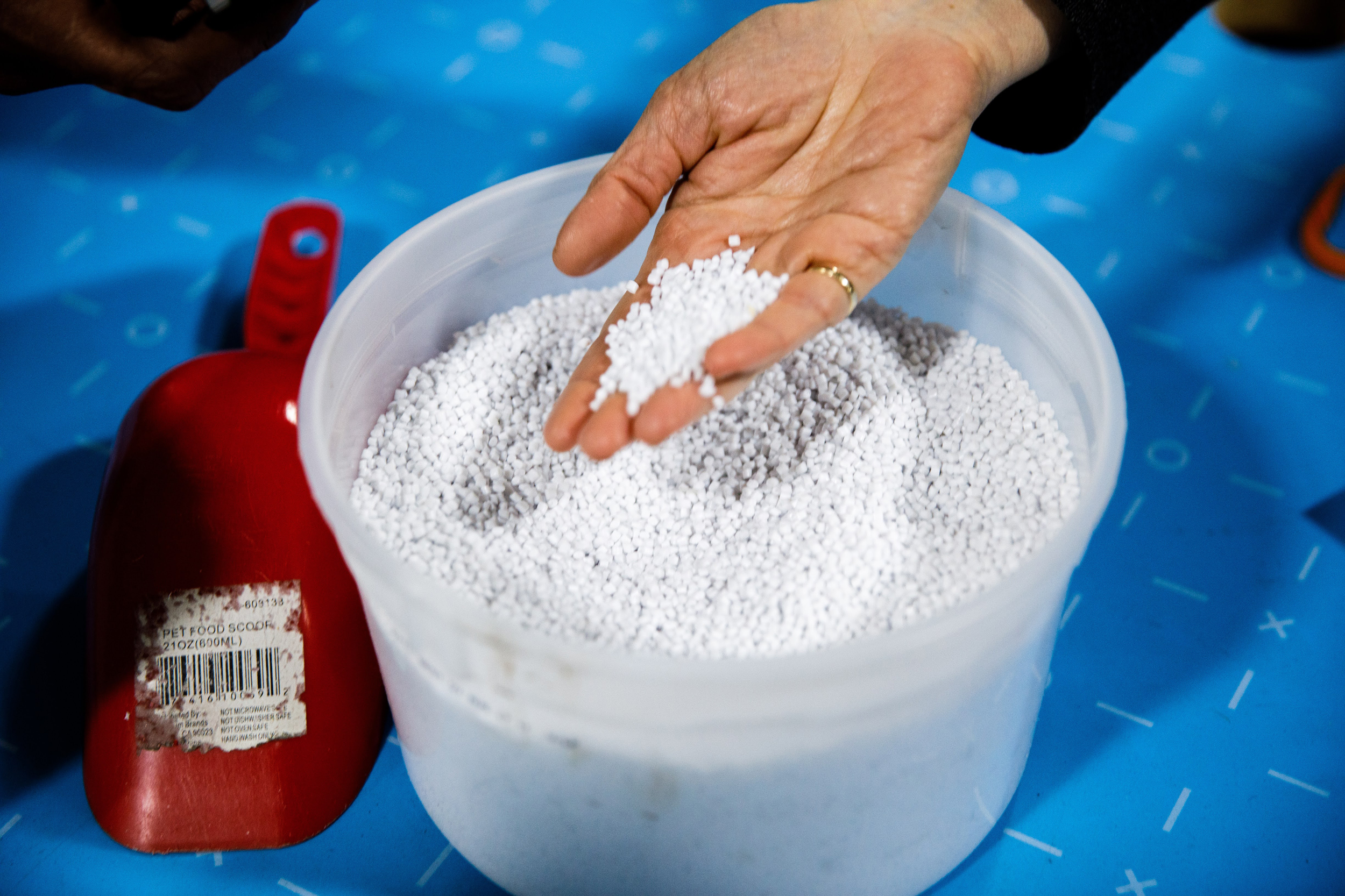 Attendees of the microfactory launch event inspect plastic pellets produced during the recycling process at the Goodwill Retail Operations Center in Tempe, Ariz. on Feb. 6. Credit: ASU Knowledge Enterprise/Andy DeLisle