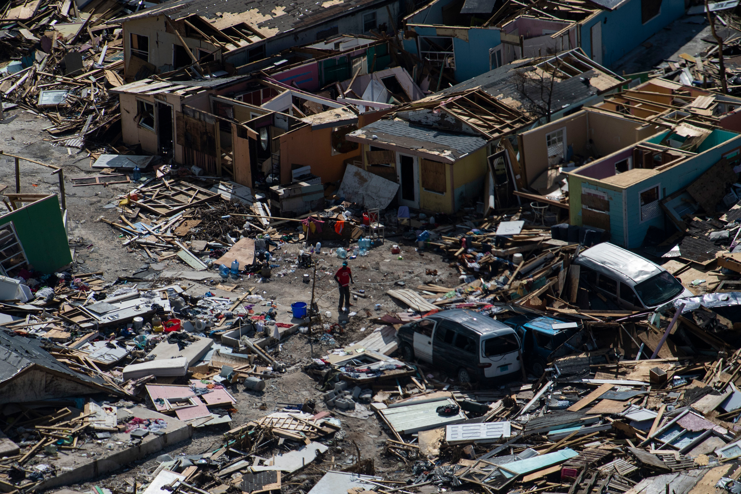 A man walks through debris in Marsh Harbour, Bahamas on Sept. 9, 2019 in the aftermath of Hurricane Dorian. Credit: Carolyn Van Houten/The Washington Post via Getty Images