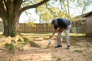 Ricky Jordan inspects an abandoned well with a temporary cap in the backyard of a home on March 8, 2023 in Oil City, La. Credit: Cooper Neill/The Washington Post via Getty Images