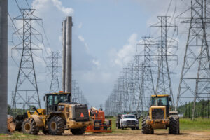 Service technicians work to install the foundation for a transmission tower at the CenterPoint Energy power plant on in Houston, Texas. Credit: Brandon Bell/Getty Images