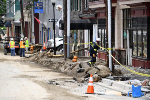 A Howard County Special Operations worker evaluates damage on Ellicott City's Main Street after a flash flood hit the Maryland town in May 2018. Credit: Katherine Frey/The Washington Post via Getty Images