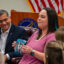 Elizabeth Goldman, an IVF patient, shows a photo of her child during a roundtable with U.S. Health and Human Services Secretary Xavier Becerra on Feb. 27 in Birmingham, Ala. Photo credit: Lee Hedgepeth/ Inside Climate News