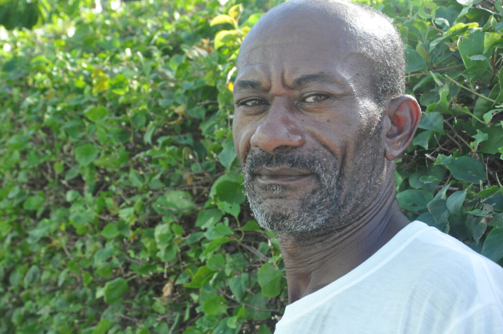 Ezekiel Bobb, who lives near the ocean at Handsome Bay, Virgin Gorda, has suffered from the odor of decaying sargassum in recent years. He has tried to do his part by using it for fertilizer in his garden, but he is unable to make much dent in the massive amounts that wash ashore. Credit: Freeman Rogers/The BVI Beacon