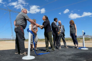 Secretary of the Interior Deb Haaland (third from left) shakes hands with James Wynne from the International Brotherhood of Electrical Workers after the ribbon cutting for the Ten West Link on April 25. Credit: Noel Lyn Smith/Inside Climate News