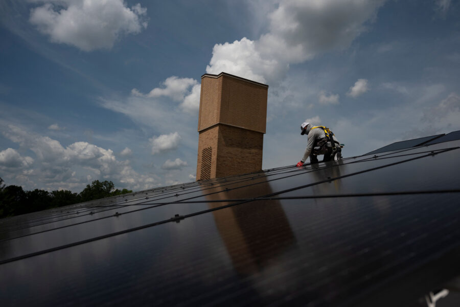 Solar panels are installed on the roof of a church in Alexandria, Va. Credit: Andrew Caballero-Reynolds/AFP via Getty Images