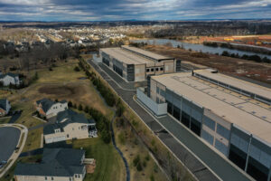 Amazon data centers are seen next to Loudoun Meadows houses in Aldie, Va. Credit: Jahi Chikwendiu/The Washington Post via Getty Images
