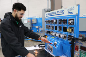 Muhammud Abu-Kass demonstrates how to work the training equipment at Guilford Tech Community College. The equipment trains him to be ready to work at Toyota’s first and only battery manufacturing plant in the U.S. Credit: Nicole Norman/Medill News Service