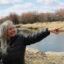 Leslie Hagenstein indicates where the New Fork River flows through her property on Mar. 27. She signed up for a program that pays her to pause irrigation on her land in order to save Colorado River water. Some experts say the System Conservation Pilot Program, or SCPP, is costly and may not be the most effective way to save Colorado River water. Credit: Alex Hager/KUNC
