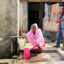 Khadiza Akhter fills up pitchers with water from a spigot in front of her home in Savar, Bangladesh. Credit: Mahadi Al Hasnat/Grist