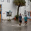 People walk through a flooded street caused by the rain and storm surge from Hurricane Debby on August 5 in Cedar Key, Florida. Credit: Joe Raedle/Getty Images