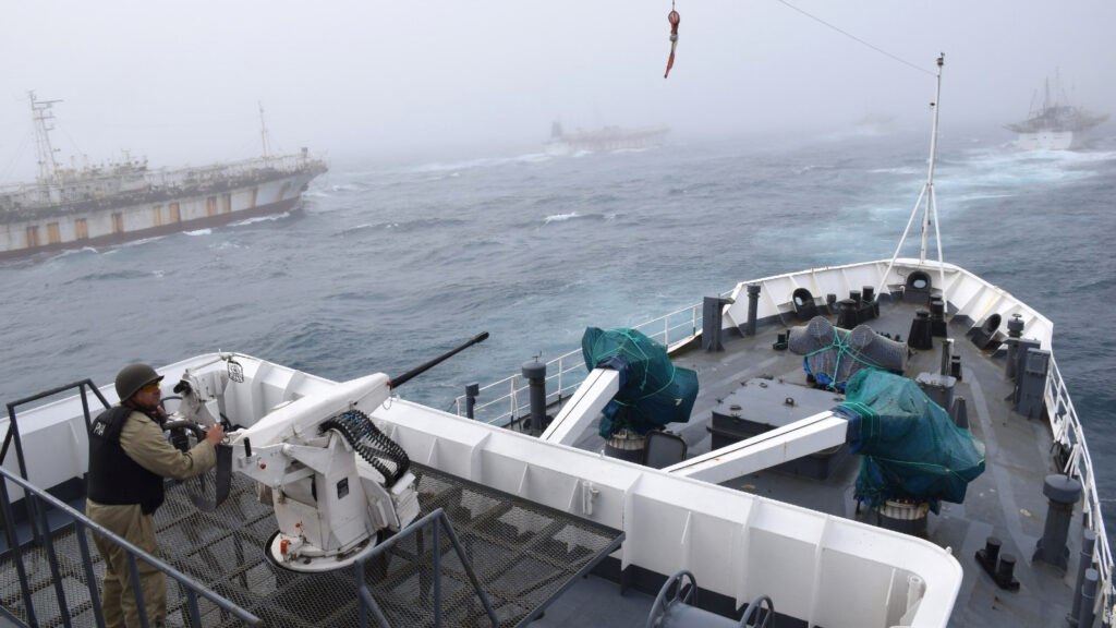 On Feb. 24, 2018, the Argentine Coast Guard discovered the Jing Yuan 626 fishing illegally within Argentina’s EEZ. Here, an Argentine Coast Guard member watches as Jing Yuan 626 and several other foreign fishing vessels crowd around during a pursuit. Credit: Javier Giannattasio