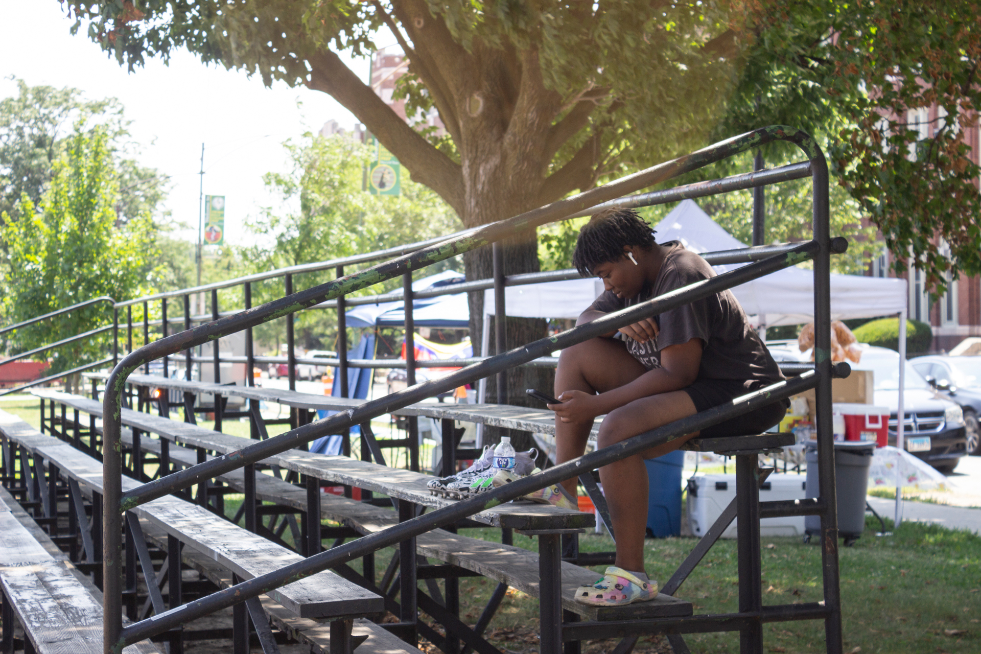 N’dyia Mahon sits on the bleachers at Kelly Park after flag football practice on Aug. 13. Credit: Aydali Campa/Borderless Magazine