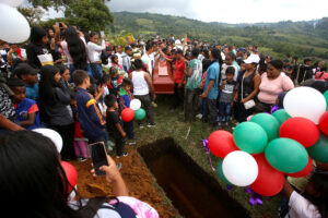People attend the burial of 14-year-old Colombian environmental activist Breiner David Cucuname, who was shot dead during a rural security patrol on Jan. 14, 2022 in the indigenous community of Las Delicias in Colombia’s Cauca Department. Credit: STR/AFP via Getty Images