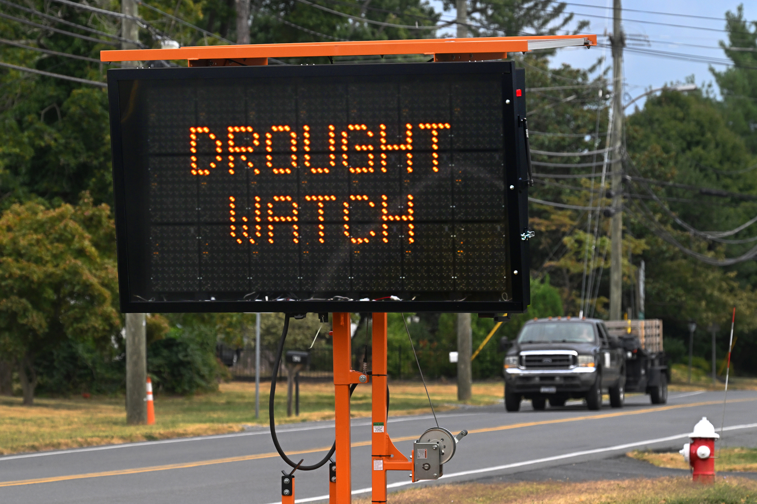 As drivers enter Purcellville, Virginia, they are reminded via road signs that farms in the area are under drought watch on Sept. 7, 2023. Credit: Michael S. Williamson/The Washington Post via Getty Images