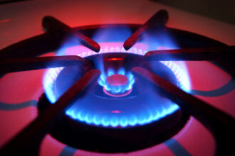 Blue flames rise from the burner of a natural gas stove in Orange, California. Credit: David McNew/Getty Images