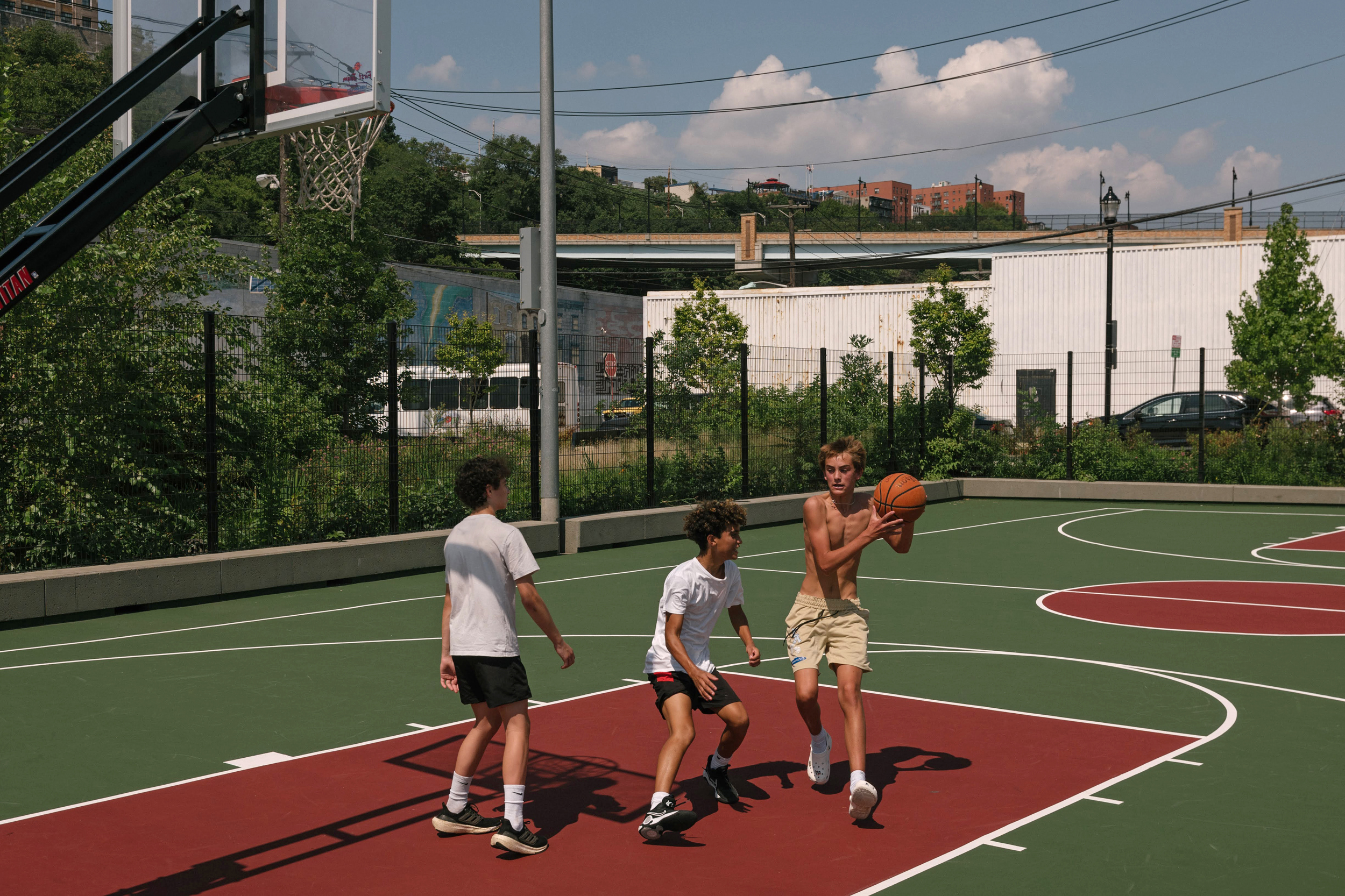 Basketball players practice on the court at ResilienCity Park. Credit: Caroline Gutman/Inside Climate News