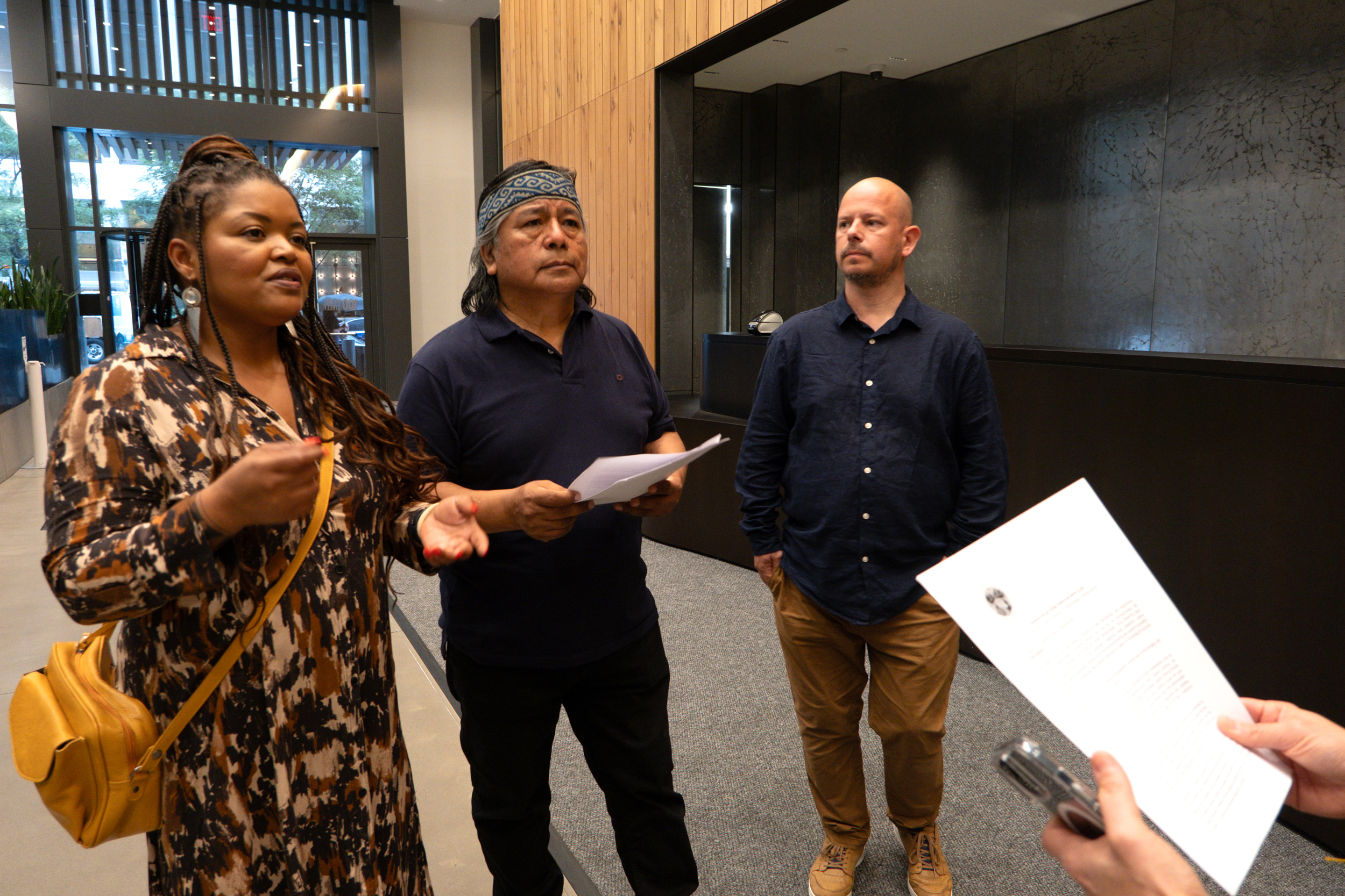 From left: Sandra Silva, Jorge Nawel and Gonzalo Verges deliver a letter to the Securities and Exchange Commission's Manhattan office on Sept. 26. Nawel's Indigenous Mapuche community in Argentina has been heavily impacted by fracking since the early 2010s. Credit: Keerti Gopal/Inside Climate News
