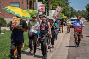 Activists in Pueblo, Colorado, march during a utility justice action organized by Mothers Out Front and 350 Colorado. Credit: Mothers Out Front