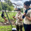 Sam Votzke (left) demonstrates how she performs research work with her field assistant, Olivia Bond. Credit: Aman Azhar/Inside Climate News