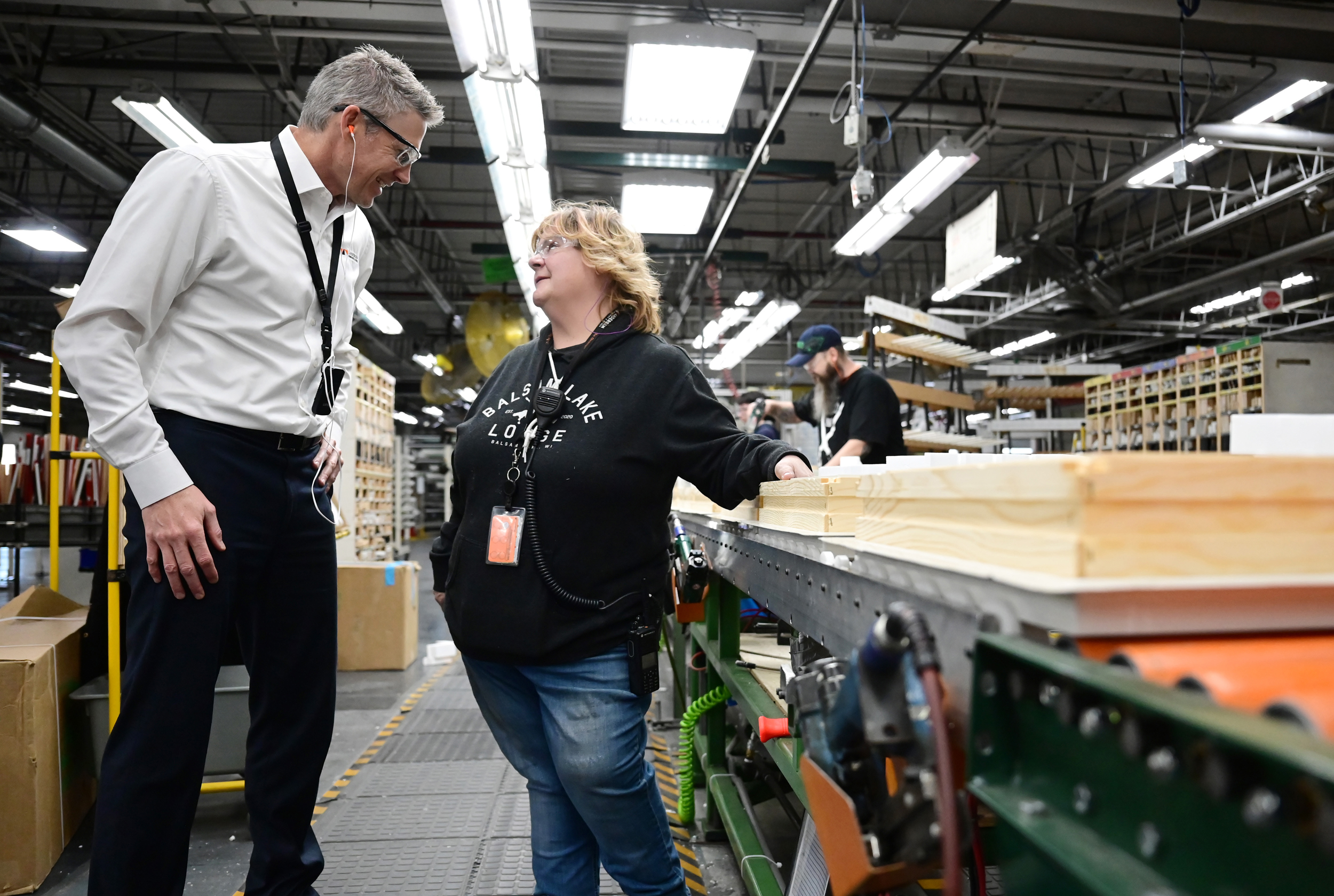 Chris Galvin, President of Andersen Corp., talks with employee Wendy Ingalls at the company's Bayport, Minn. factory on Dec. 6, 2022. Andersen Corp. is a manufacturer of windows and doors. Credit: John Autey/St. Paul Pioneer Press via Getty Images