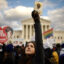 A large crowd gathers on the National Mall, holding signs and banners advocating for anti-abortion causes, with the U.S. Supreme Court visible in the background.