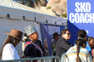 Miss Navajo Nation Ranisha Begay listens to remarks by Democratic vice presidential candidate Tim Walz during a campaign rally on Oct. 26 in Window Rock, Ariz. Credit: Noel Lyn Smith/Inside Climate News