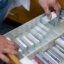 A pharmacist retrieves a package of antidepressant medication from a pharmacy drawer in Berlin. Credit: Monika Skolimowska/picture alliance via Getty Images