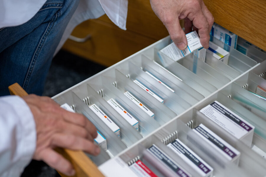 A pharmacist retrieves a package of antidepressant medication from a pharmacy drawer in Berlin. Credit: Monika Skolimowska/picture alliance via Getty Images