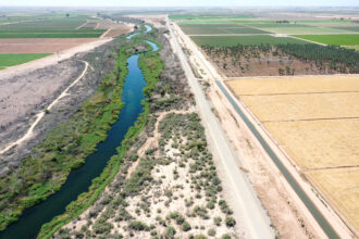 An aerial view shows the long-depleted Colorado River as it flows between California and Arizona. An irrigation ditch (right) carries the river water toward Quechan tribal land on May 26, 2023 near Winterhaven, Calif. Credit: Mario Tama/Getty Images
